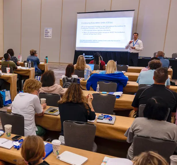 A CPI training at the front of the room giving a presentation.